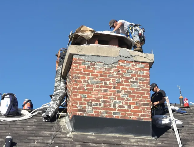 Miami Gardens Chimney Sweep installing a custom chimney crown in Miami Gardens, FL